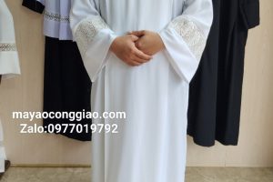 Who wears a white robe in the Catholic Church?